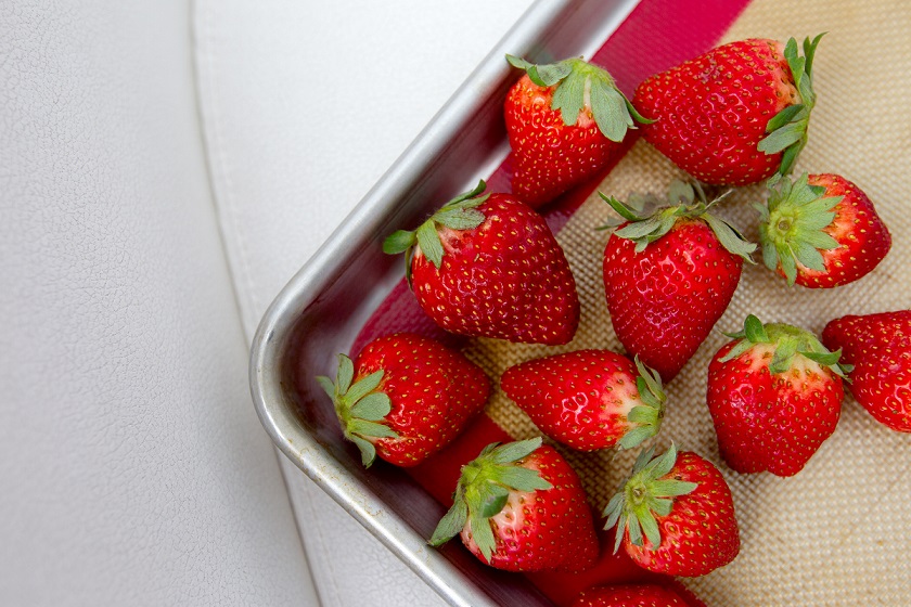 fresh strawberries on a baking sheet
